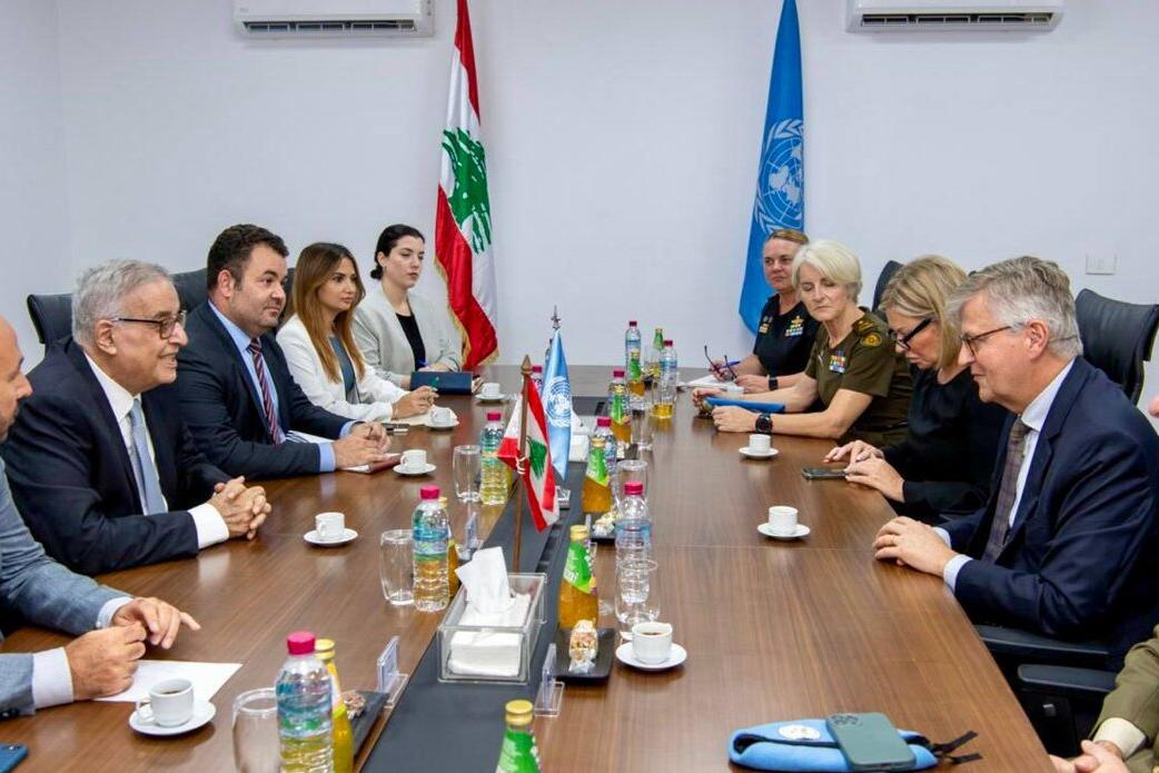 High level representatives attend a meeting around a formal table.