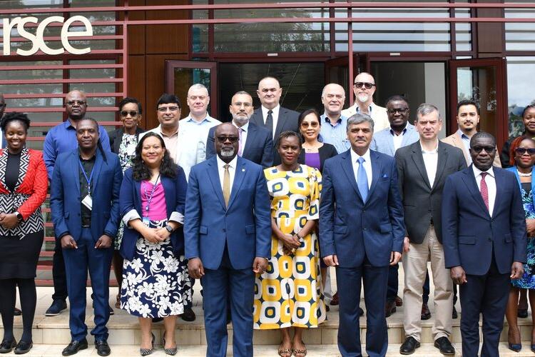 A group of staff stand in a row outside a building